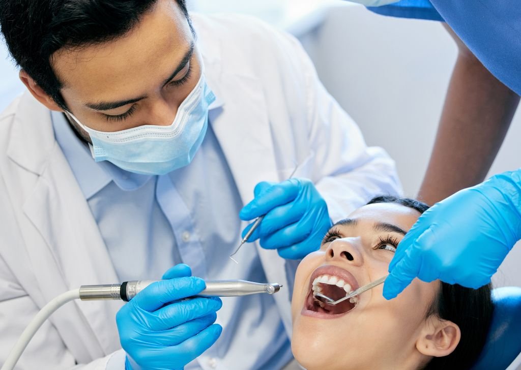 A woman getting her dental filling done at a dentist.