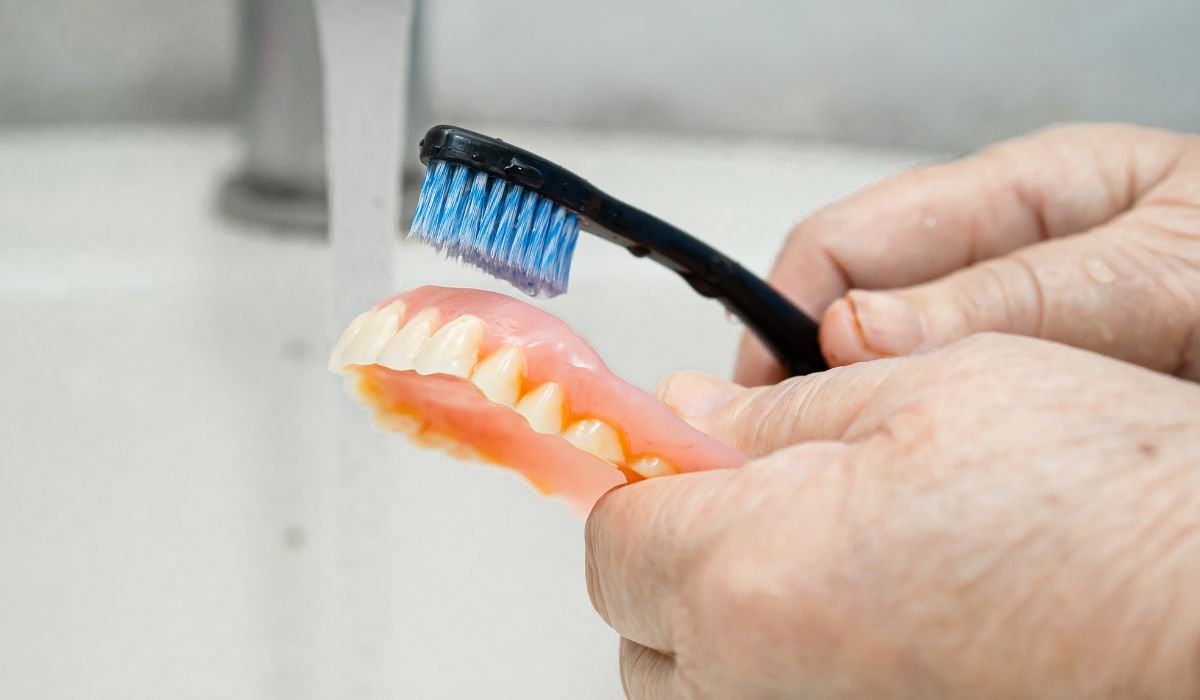 How do I clean dentures properly
