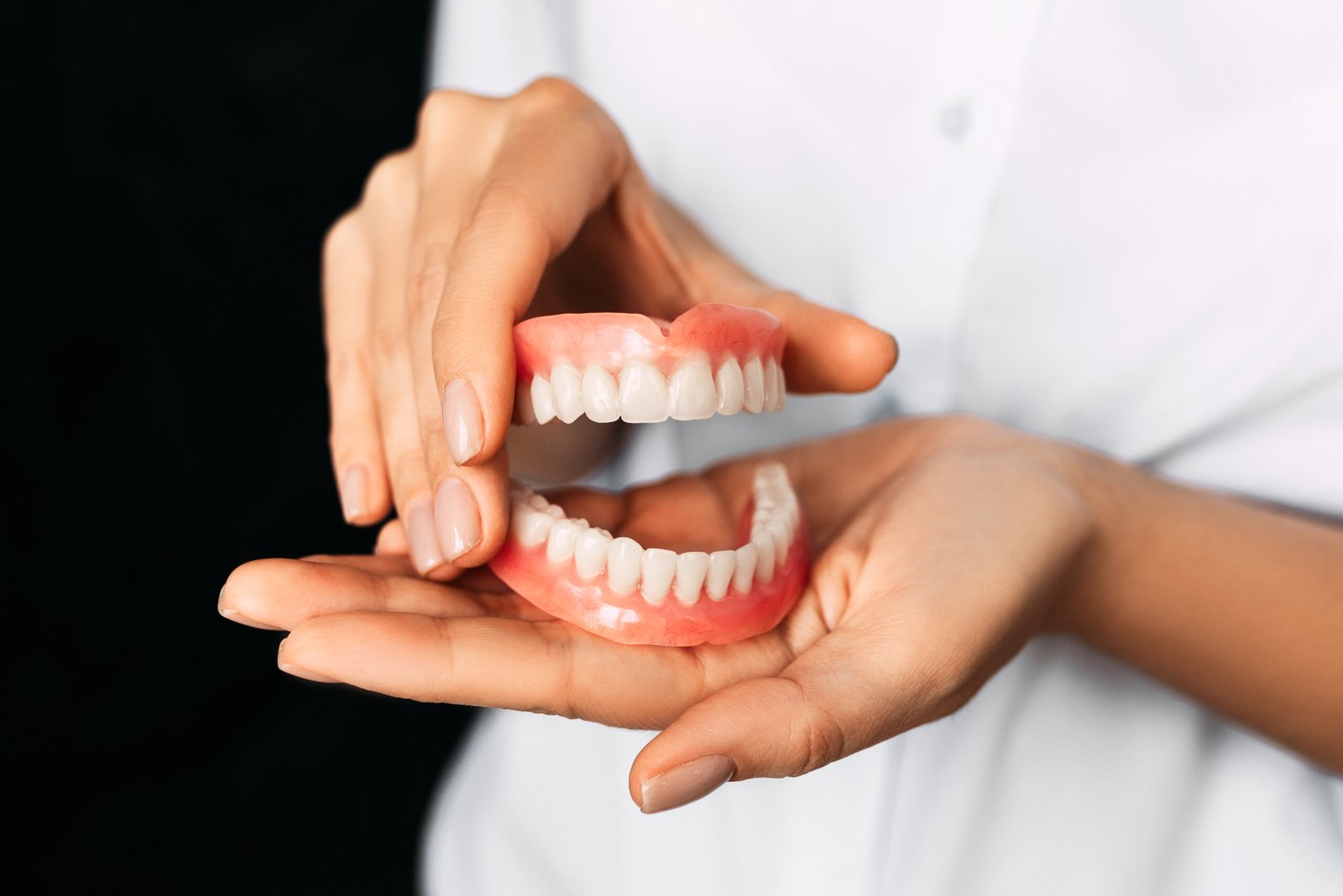 the dentist is holding dentures in his hands dent 2025 01 07 23 19 16 utc scaled