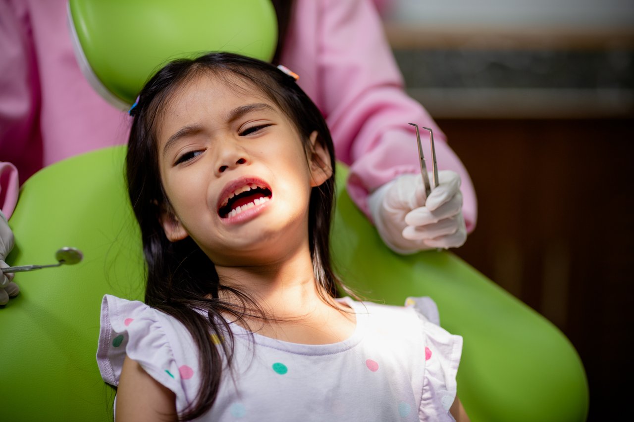 little girl scared in the dental chair